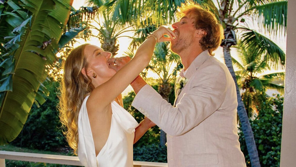 Couple eating wedding cake